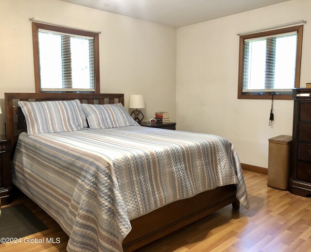 bedroom featuring multiple windows and light wood-type flooring