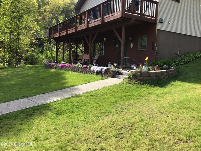 exterior space with a patio, a deck, and a lawn