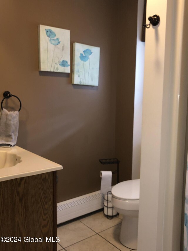 bathroom featuring vanity, toilet, tile patterned floors, and baseboard heating