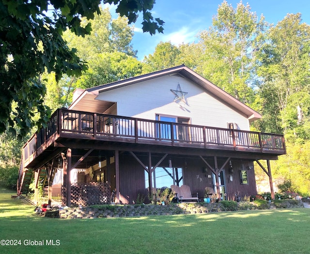 rear view of property featuring a deck and a lawn