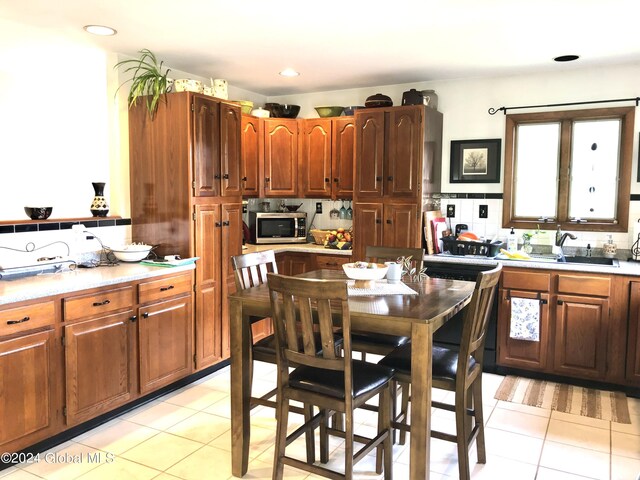 kitchen featuring sink and light tile patterned flooring