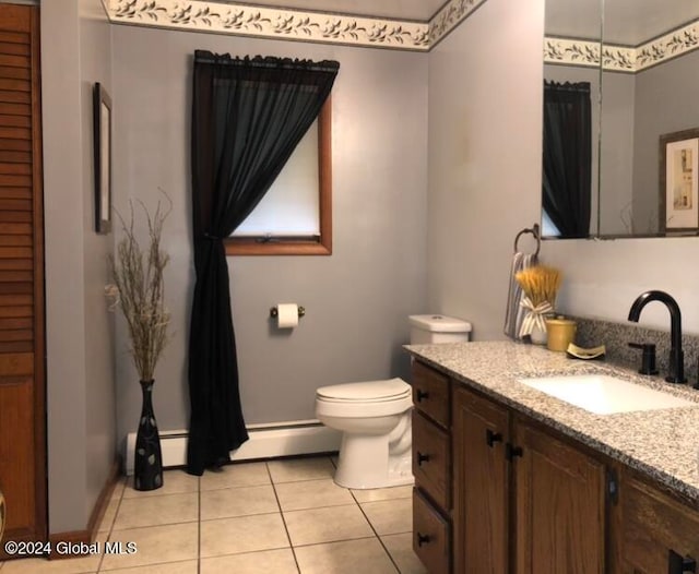 bathroom with toilet, vanity, and tile patterned flooring