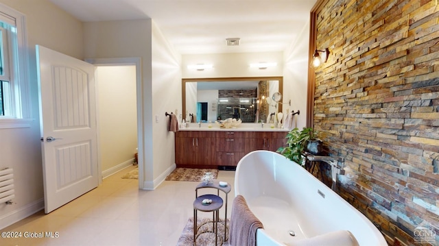 bathroom with a tub to relax in and vanity