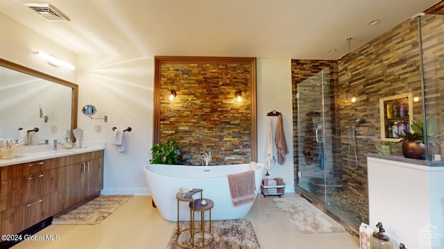 bathroom with vanity and independent shower and bath