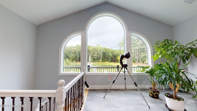 interior space with vaulted ceiling, plenty of natural light, and tile patterned flooring