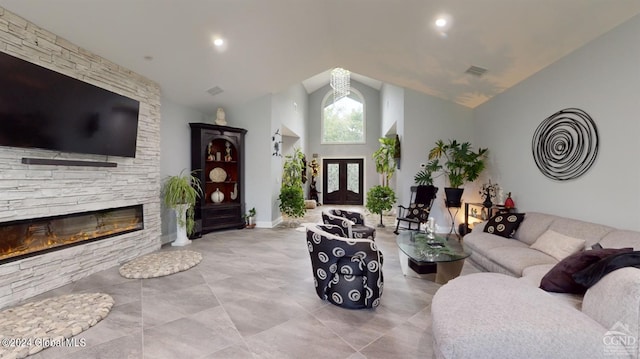 living room with high vaulted ceiling and a fireplace