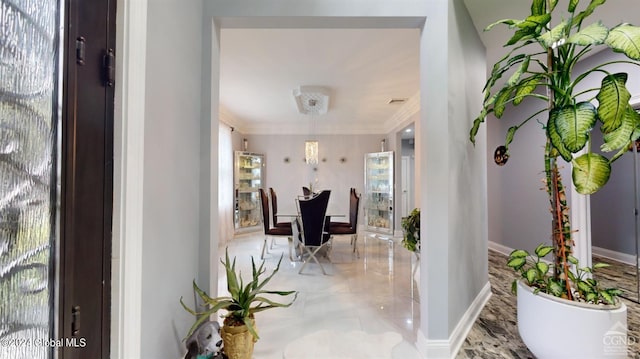 foyer entrance with plenty of natural light and ornamental molding