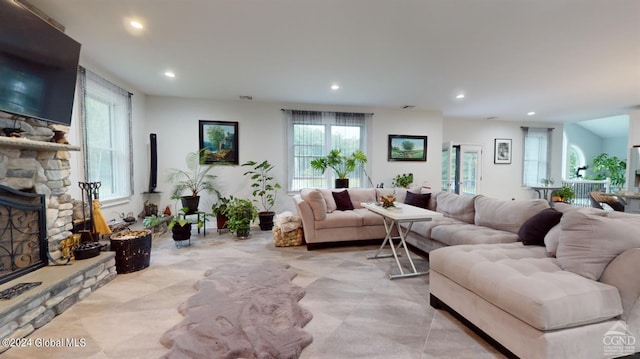 living room with plenty of natural light and a fireplace