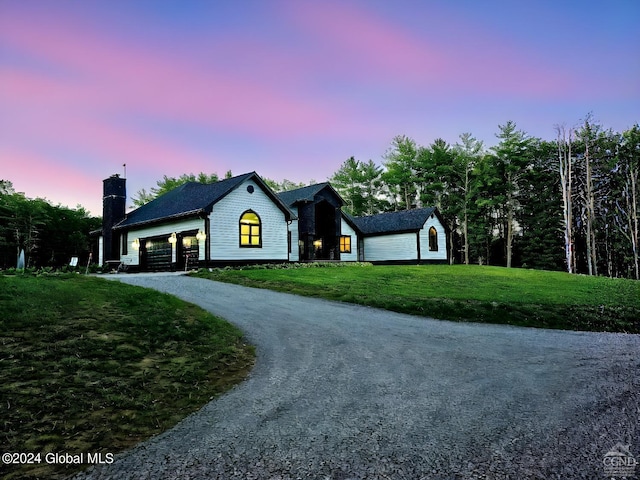 view of front of property featuring a garage and a yard