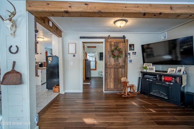 living room featuring a barn door and dark hardwood / wood-style flooring