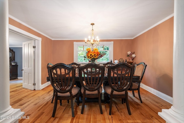 dining room with crown molding, light wood-type flooring, a chandelier, and ornate columns