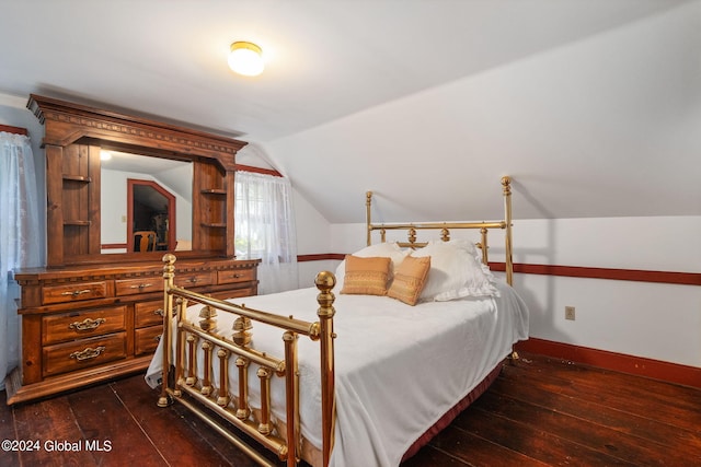 bedroom with vaulted ceiling and dark hardwood / wood-style flooring