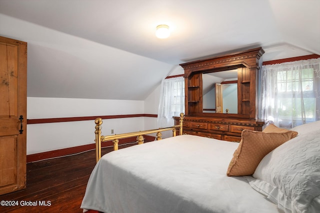 bedroom with multiple windows, lofted ceiling, and dark hardwood / wood-style floors