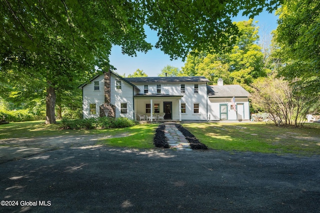 view of front facade with covered porch and a front yard