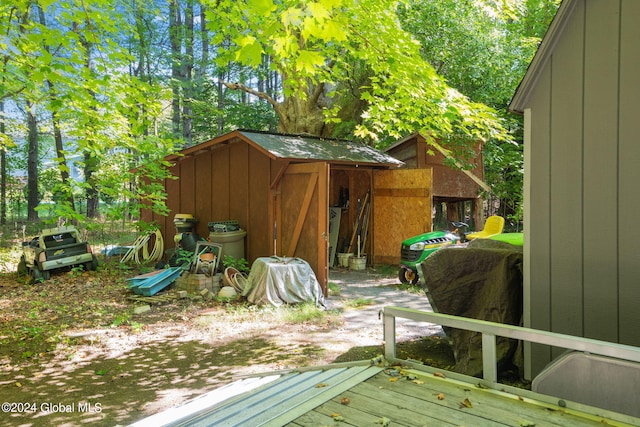 wooden terrace featuring a shed