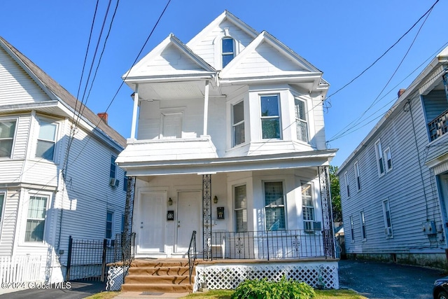 view of front of house featuring cooling unit and a porch