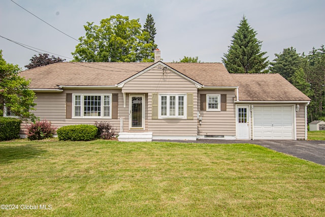 ranch-style home featuring a garage and a front yard