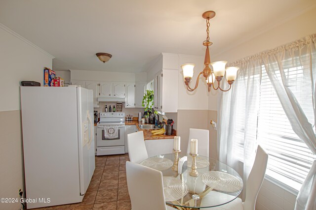 tiled dining room featuring crown molding and a chandelier