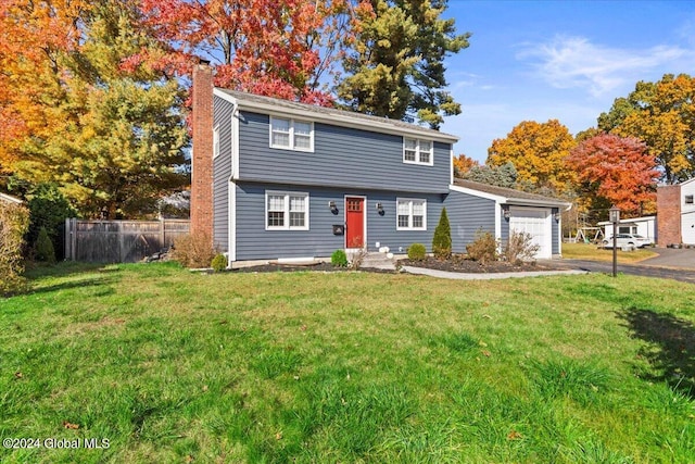 front facade featuring a front lawn and a garage