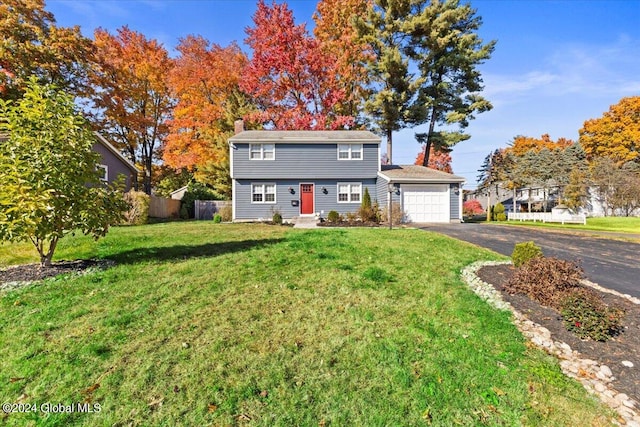 front facade featuring a front lawn and a garage