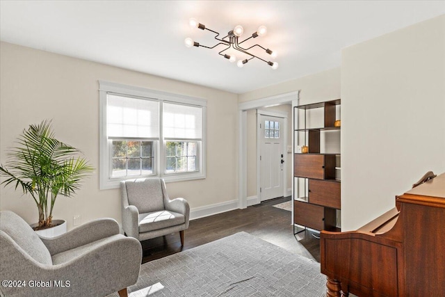 living area featuring dark wood-type flooring and a chandelier