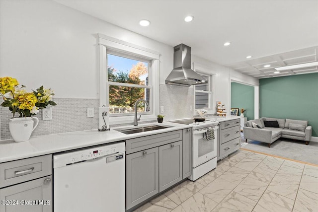 kitchen featuring extractor fan, gray cabinets, tasteful backsplash, white appliances, and sink