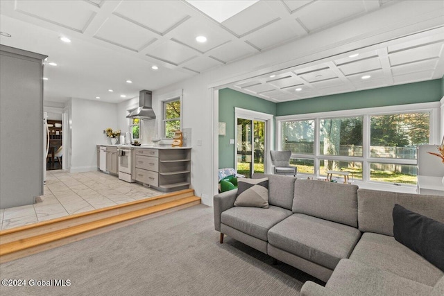 living room with light carpet, coffered ceiling, and sink