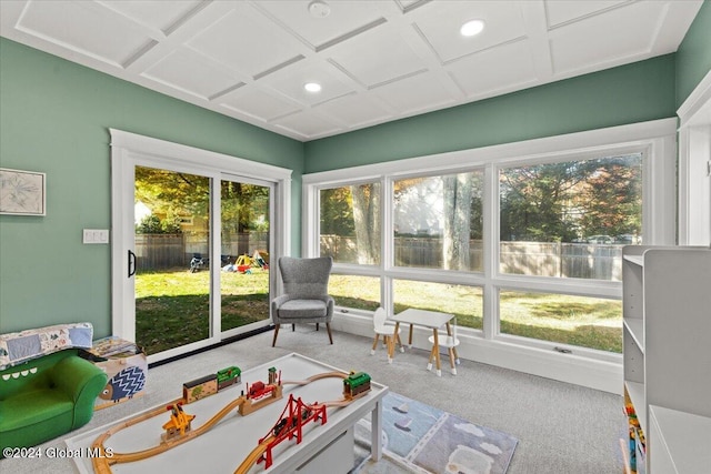 sunroom featuring a healthy amount of sunlight and coffered ceiling