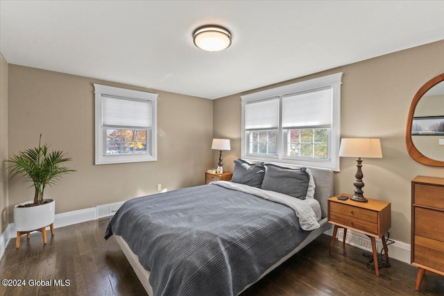 bedroom with dark hardwood / wood-style floors