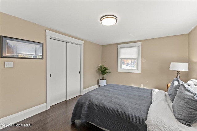 bedroom with a closet and dark hardwood / wood-style flooring