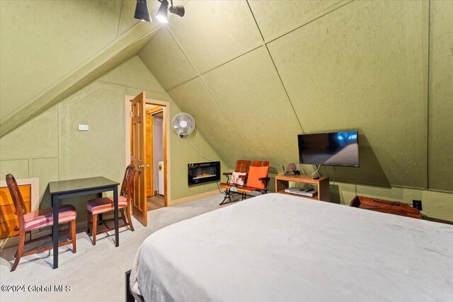 bedroom with lofted ceiling, ceiling fan, and carpet floors