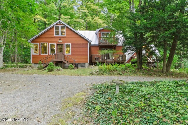 rear view of property featuring a wooden deck