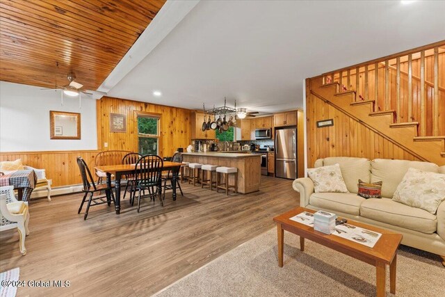 living room featuring light hardwood / wood-style flooring, ceiling fan, and sink