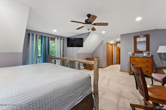 bedroom featuring baseboard heating, lofted ceiling, light carpet, and ceiling fan