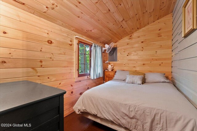 bedroom with wood walls, lofted ceiling, and wood ceiling