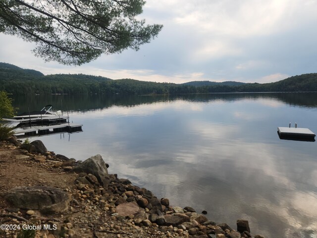 property view of water featuring a mountain view and a boat dock