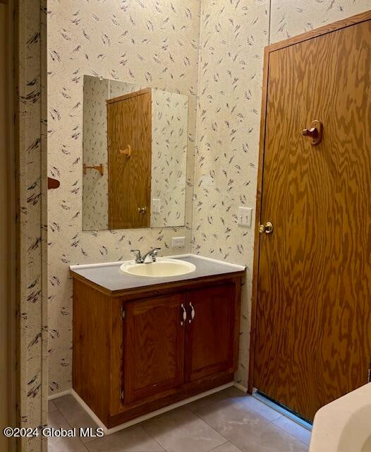 bathroom with tile patterned flooring and vanity