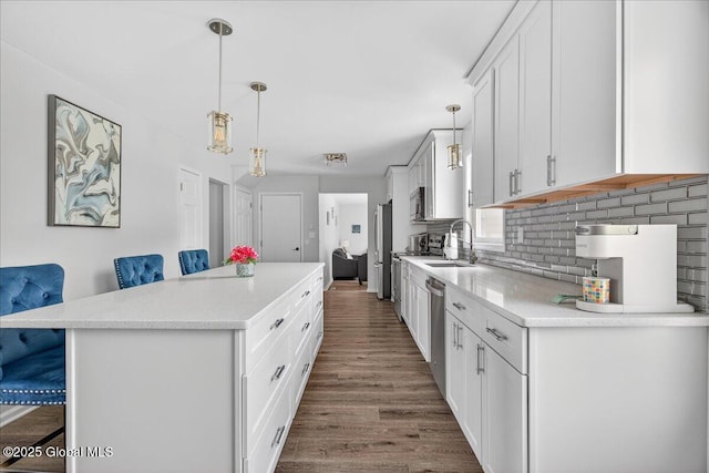 50 Whipple Way, Altamont, NY 12009 - kitchen featuring a center island, a sink, wood finished floors, and light countertops