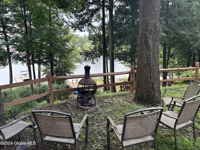 exterior space featuring a fire pit and a water view