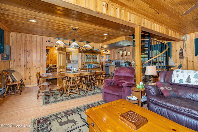 living room with light wood-type flooring, wood walls, and wooden ceiling