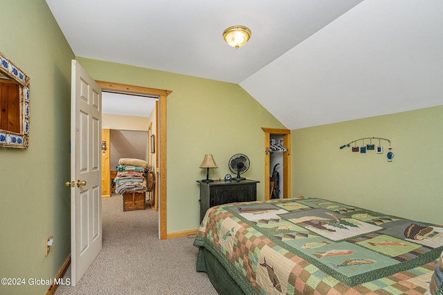 carpeted bedroom featuring lofted ceiling