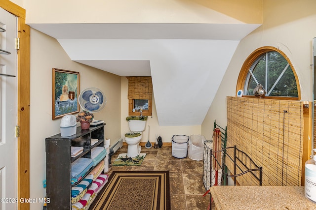 interior space featuring vaulted ceiling and baseboard heating