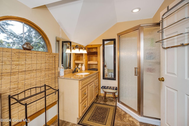 bathroom with vanity, lofted ceiling, an enclosed shower, and tile patterned floors