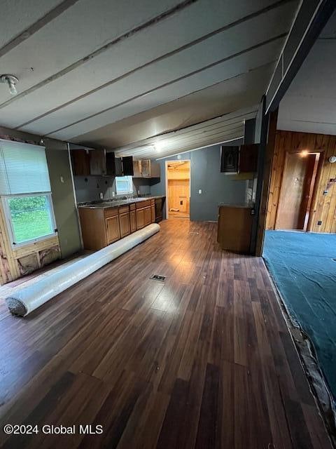 interior space featuring wood walls and dark hardwood / wood-style floors