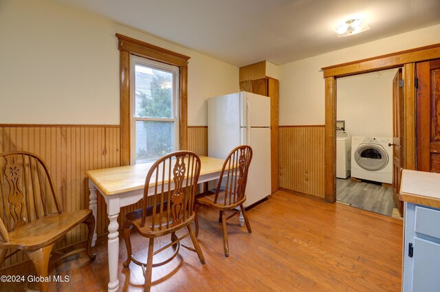 dining space featuring washing machine and dryer and light wood-type flooring