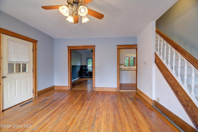 empty room with ceiling fan and hardwood / wood-style flooring