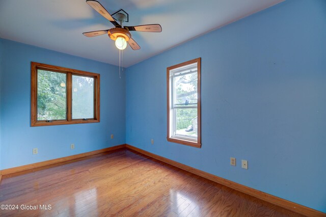 unfurnished room featuring ceiling fan and light hardwood / wood-style floors