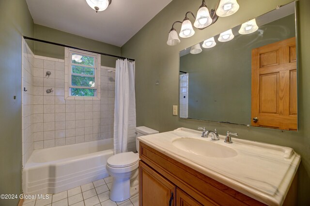 full bathroom with tile patterned floors, shower / bath combo, toilet, and vanity