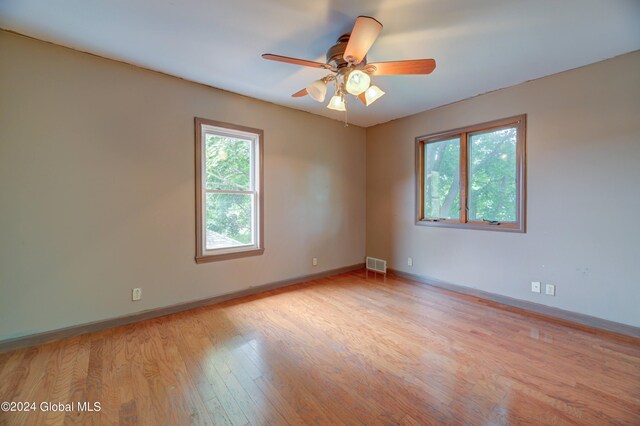 unfurnished room with ceiling fan and light hardwood / wood-style flooring