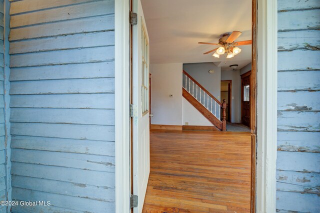 view of exterior entry featuring a balcony and ceiling fan